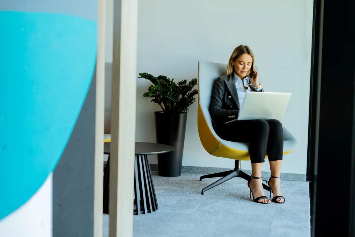 A professional preparing their CV on a laptop