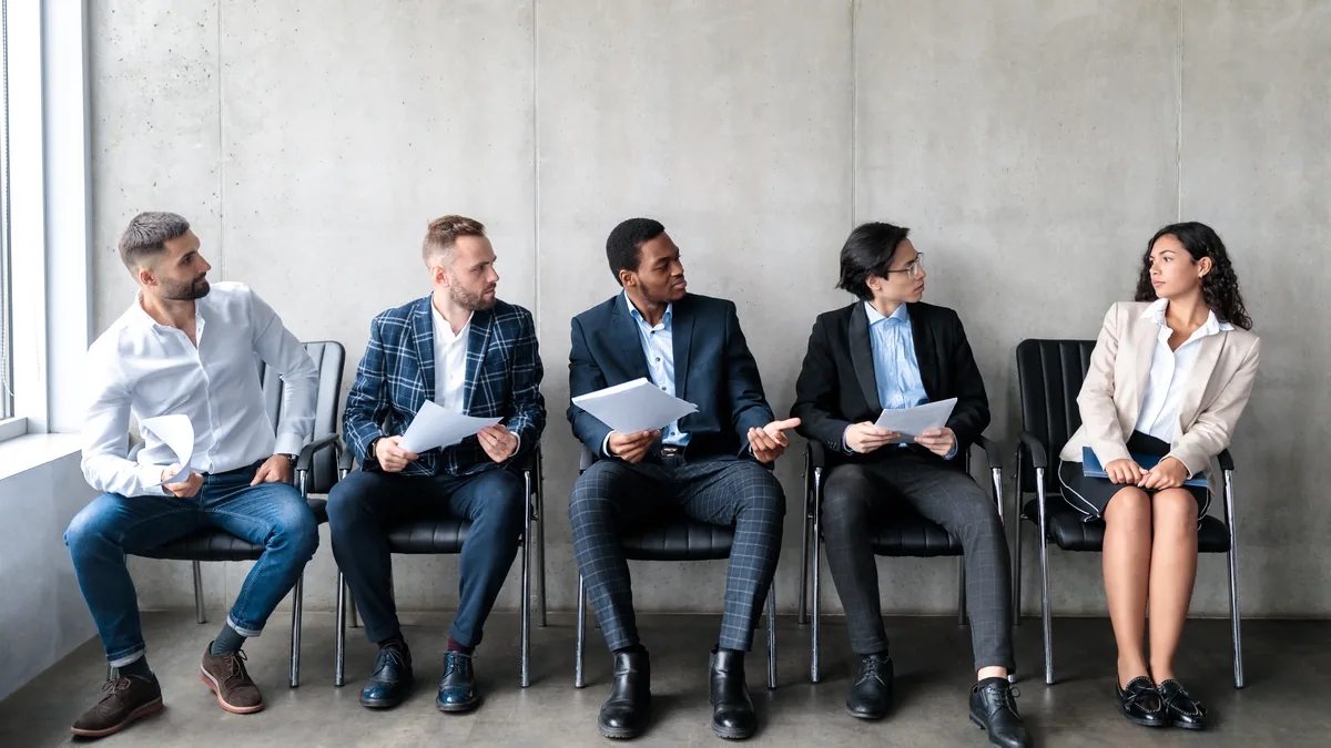 A hiring panel reviewing candidate profiles together